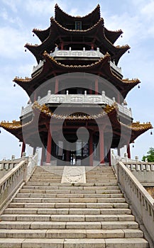 A pagoda with stone stairs in the front