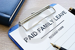 Paid family leave form in clipboard and notepad.