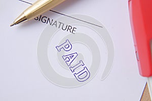 Paid invoice and Rubber Stamp on paper ,