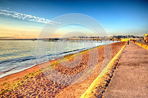 Paignton beach Devon England colourful HDR on warm summer morning with blue sky photo