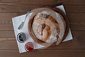 pain de campagne french bread with strawberry jam isolated on wooden table