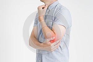 Pain in elbow, joint inflammation with red dot on gray background photo
