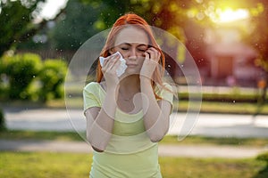 Pain in eyes. Young redhair woman sneezing. Pollen Allergy symptoms