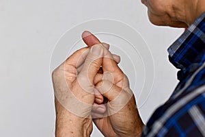 Pain in fingertip of Asian man. Concept of cellulitis and finger problems photo