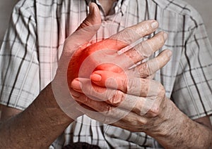 Pain in hand of Asian elder man. Concept of hand pain, arthritis and joint problems
