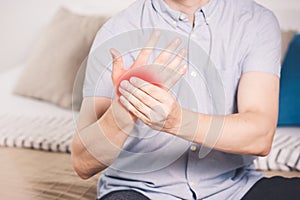 Pain in hand, man suffering from carpal tunnel syndrome at home