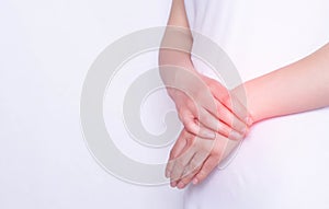 Pain and inflammation in the hand on the wrist of a girl, carpus, tendonitis and podagra, white background, copy space