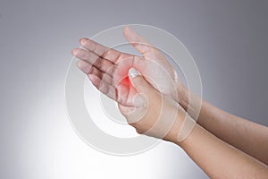 Pain in the joints of the hands. Carpal tunnel syndrome. Pain in the human body on a gray background