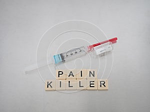 Pain Killer with Syringe and Empty Vial on its Side