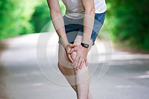 Pain in knee, joint inflammation, massage of male leg, injury while running, trauma during workout
