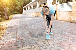 Pain in the leg of the girl after a sports run, morning training, stretching of the leg