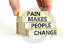 Pain makes people change symbol. Concept words Pain makes people change on wooden blocks on a beautiful white table white