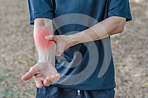 Pain in a man wrist. Male holding hand to spot of wrist pain