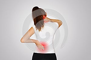 Pain in the neck and back. A young woman suffers from pain in the neck and back. Spine osteoporosis. Scoliosis. The place of pain