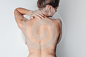 Pain in the neck. Women neck with pleats. Problems with stooping. Rear view of a middle-aged woman