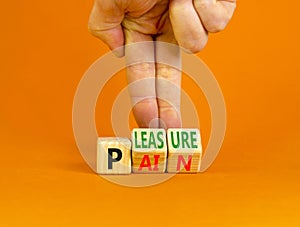 Pain or pleasure symbol. Concept words Pain or Pleasure on wooden cubes. Businessman hand. Beautiful orange table orange