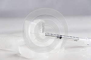 Pain reliever concept.Syringe and cold liquid on white background
