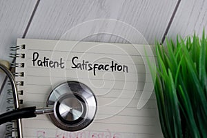 Pain Satisfaction text write on a book isolated on office desk. Healthcare/Medical concept