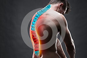 Pain in the spine, a man with backache, injury in the human back, chiropractic treatments concept photo