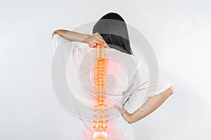 Pain in the spine, woman with backache on gray background