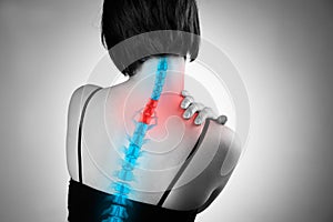 Pain in the spine, woman with backache, injury in the human back and neck