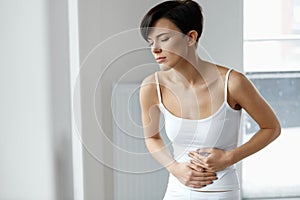 Pain In Stomach. Beautiful Woman Feeling Abdominal Pain. Health