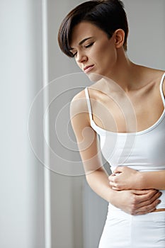 Pain In Stomach. Beautiful Woman Feeling Abdominal Pain. Health