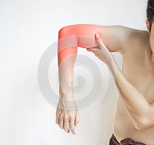 Pain in the upper arm of Asian young man. Concept of elbow  and forearm pain, injury or muscle spasm