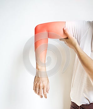 Pain in the upper arm of Asian young man. Concept of elbow  and forearm pain, injury or muscle spasm