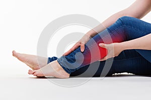 Pain in woman`s legs, massage of female feet on white background