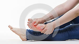 Pain in woman`s legs, massage of female feet on white background