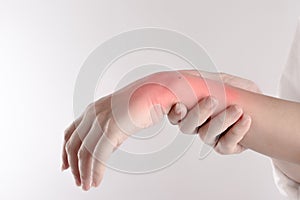 A pain in the woman`s wrist on white background