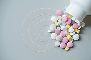 Painkiller pills heap on a gray background