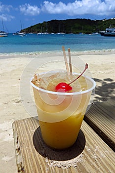 Painkiller tropical rum drink on the beach