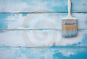 Paint brush on a blue and white wooden background