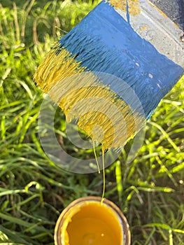 Paint brush in blue and yellow tones. Symbol of Ukraine. Ukrainian flag.