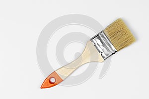 Paint brush close-up against a white background, natural shadow, copy space, top view