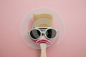 Paint brush diy character with sunglasses and sad face