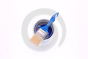 paint brush on an open blue paint can isolated on white background