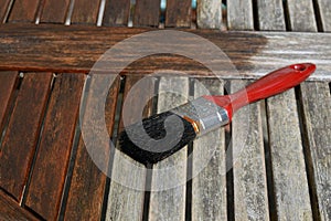 Paint brush painting wooden decking