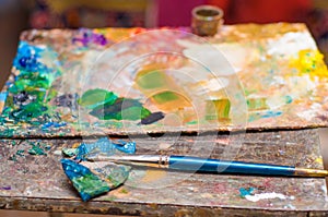 Paint brush, palette of colors. Still life, art workshop.