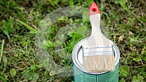 Paint brush placed on top of a can