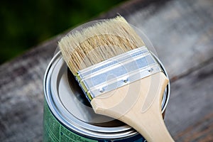 Paint brush placed on top of a can