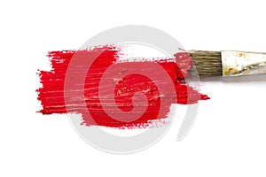 Paint brush with red color and paint stroke on white ba