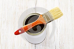 Paint brush and varnish can, paintbrush and transpicuous lacquer photo