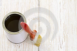 Paint brush and varnish can, paintbrush and wooden lacquer photo