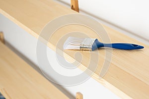 Paint brush on a wooden shelf