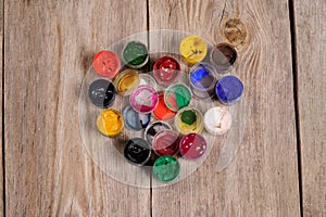 Paint and brushes depicting the heart on the wooden background