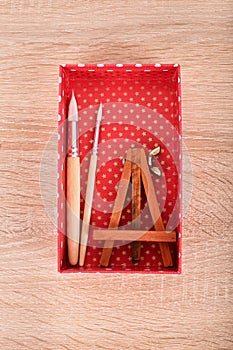 Paint brushes and easel in a box