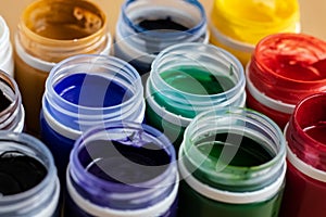 Paint brushes and watercolor paints,  tempera paints on the table in a workshop